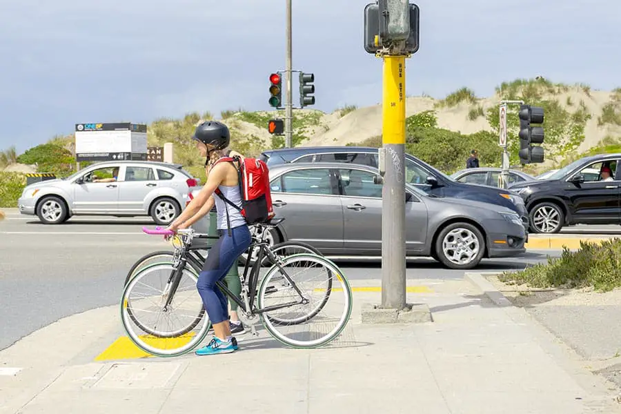 Two cyclists waiting at red light
