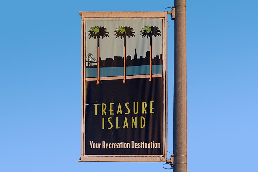 Treasure Island banner on street post with blue sky in background