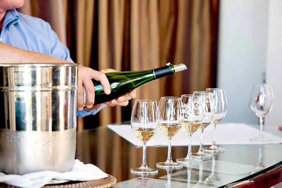 Man pouring wine into wine glasses