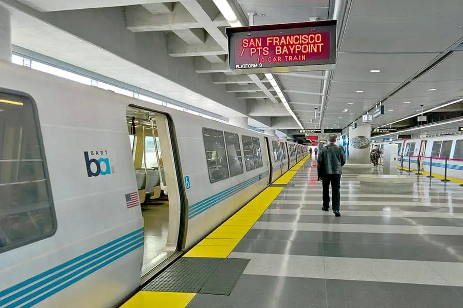 Transit train with man walking beside it