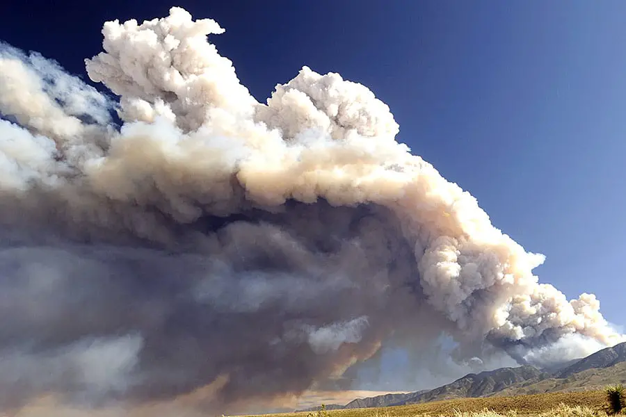 Smoke from a wildfire with blue sky in background