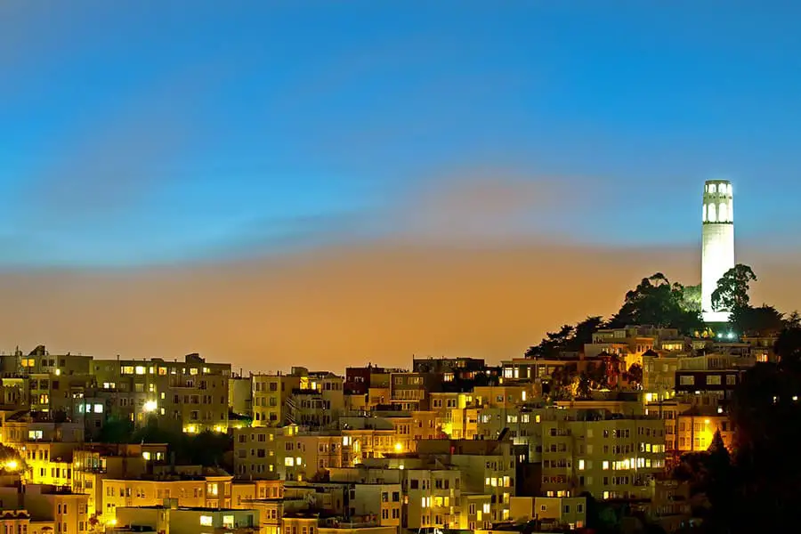 City buildings and Coit Tower at dusk