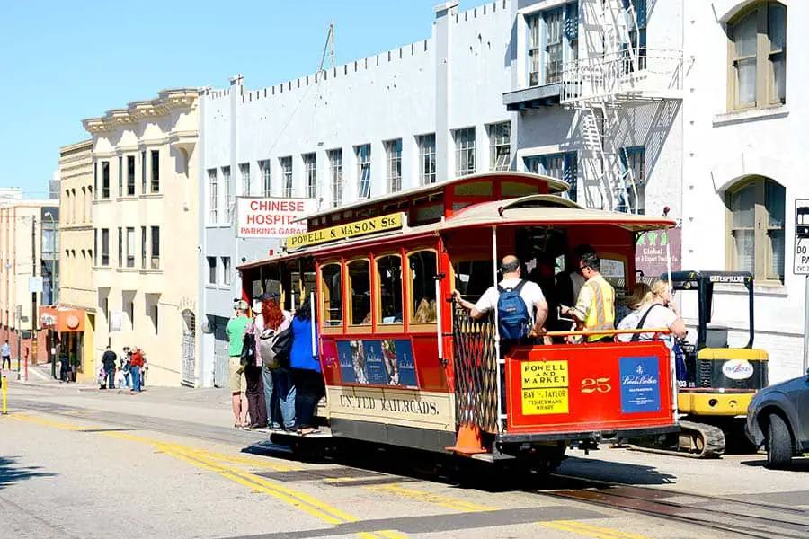 People riding red cable car