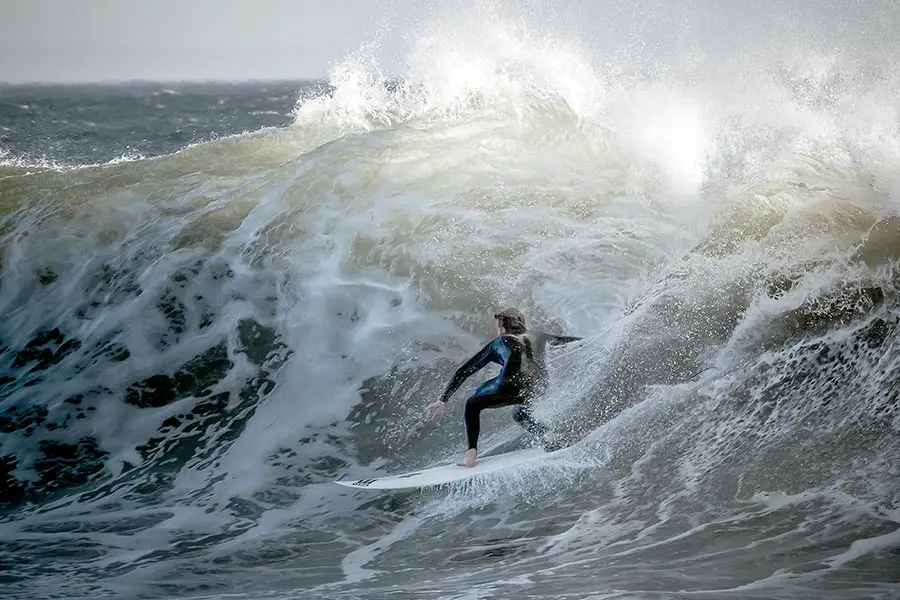 Surfer riding big wave at El Capitán State Beach