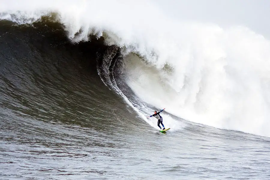 Surfer riding big wave at Half Moon Bay