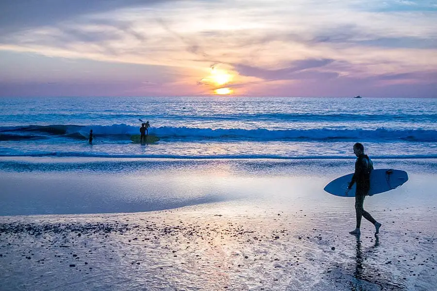 Surfers on beach at San Clemente during sunset
