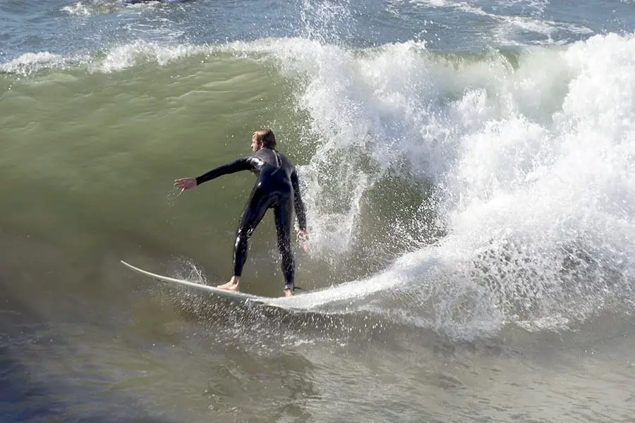 Surfer in wet suit riding a wave