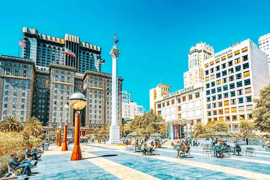 People enjoying the weather at Union Square, upscale shops in background