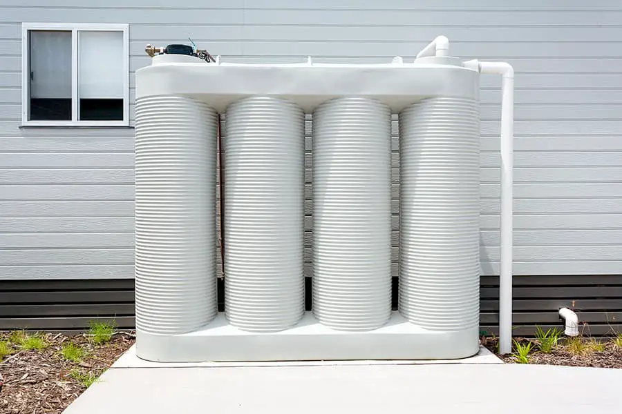 Four chambered rainwater tank by house