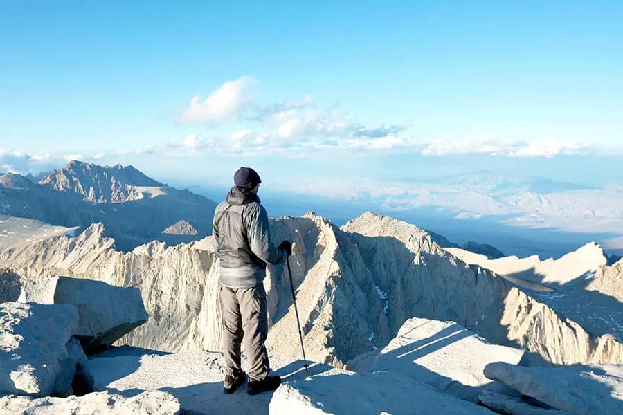 Man looking at spectacular view from the top of Mount Whitney