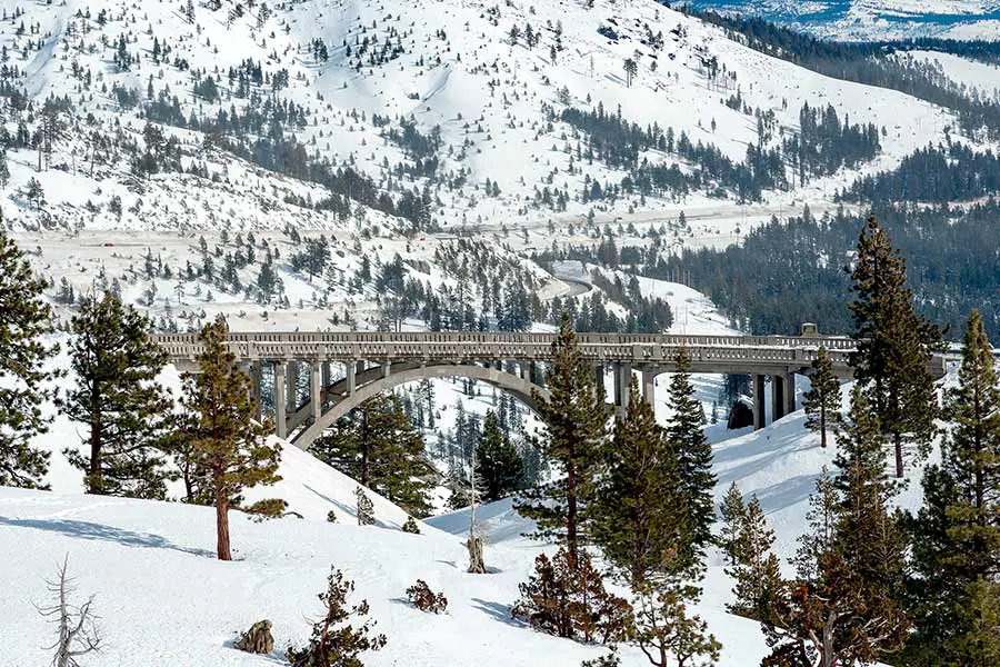 Snow covered mountains and Donner Summit Bridge