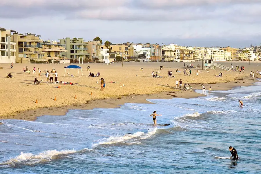 People on beach with buildings in the background