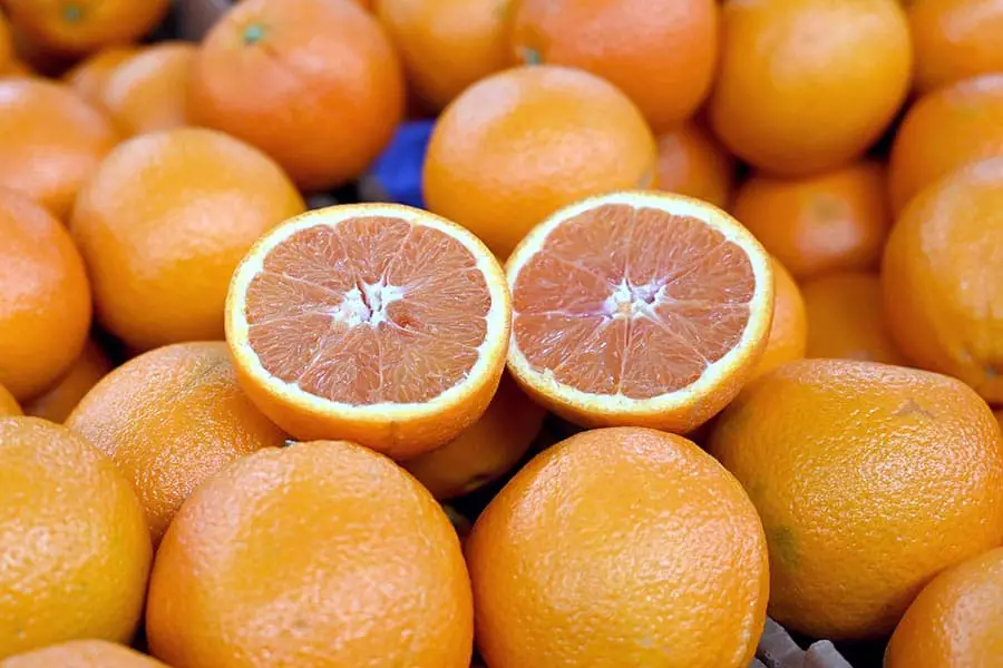 Cara Cara orange cut in half in basket of oranges