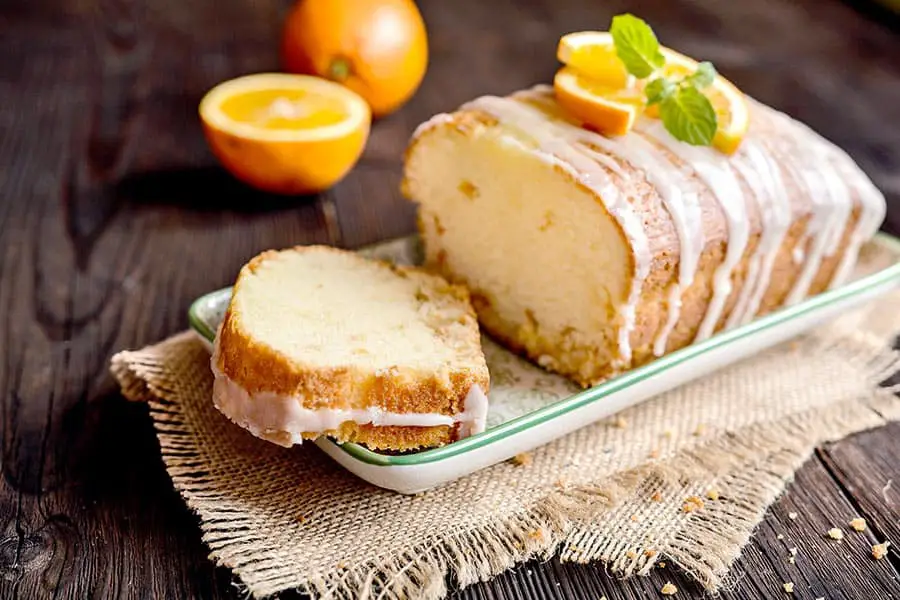 Loaf of orange bread with powdered sugar icing